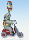 Jouet mécanique en métal, tôle et fer blanc : jouet mécanique éléphant sur vélo rouge